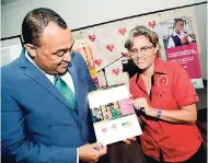  ?? BROWN/PHOTOGRAPH­ER RUDOLPH ?? Dr Christophe­r Tufton, minister of health, and Deborah Chen, executive director of the Heart Foundation of Jamaica, look at the findings of the 2016-2017 Obesity Prevention Campaign Survey.