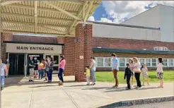  ?? Kathleen Moore / Times Union ?? Voters wait in a line that stretched down the hallway at Bethlehem High School, out the door, and to the parking lot. Staffers were sent outside to direct people to chairs inside.