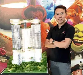  ??  ?? GIC Group’s project leader Jeffrey Chan posing with the Grand Ion Majestic scale model.