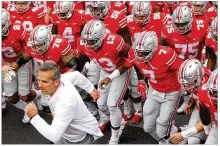  ?? DAVID JABLONSKI / STAFF ?? Ohio State head coach Urban Meyer leads his team onto the field before the Buckeyes’ 49-6 victory over Tulane on Sept. 22 at Ohio Stadium.