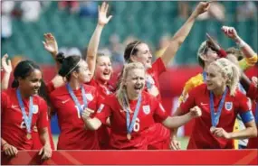  ?? JEFF MCINTOSH — THE ASSOCIATED PRESS ?? England players, including Laura Bassett (6), celebrate after defeating Germany in the FIFA Women’s World Cup third-place soccer match in Edmonton, Alberta on Saturday.