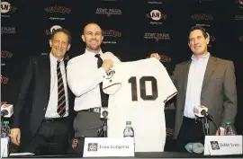  ?? MARCIO JOSE SANCHEZ — ASSOCIATED PRESS ?? Giants third baseman Evan Longoria, center, holds his new uniform next to team CEO Larry Baer, left, and general manager Bobby Evans on Friday at AT&amp;T Park.