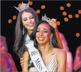  ?? Morgan Lieberman ?? Las Vegas Review-journal Andrea Martinez is crowned Miss Nevada 2017 on Friday by Miss Nevada 2016 Bailey Gumm at Tropicana Theater.