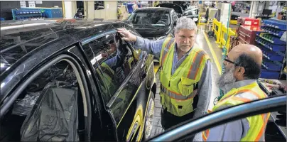  ?? CP PHOTO ?? Sales fell in eight of the 21 industries tracked by Statistics Canada, with most of the decline attributed to the transporta­tion equipment sector that includes motor vehicles. Ford Edge vehicles stand on a production line at the Ford Assembly Plant in...