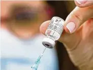  ?? Jack Guez / AFP via Getty Images ?? Social media videos have baselessly said government microchips could go into coronaviru­s vaccines.