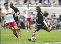  ?? Associated Press ?? Los Angeles FC defender Diego Palacios (12) passes against New York Red Bulls forward Patryk Klimala (9) during the first half on Sunday in Los Angeles. Palacios scored a goal and MLSleading LAFC won 2-0.