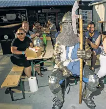  ??  ?? This fighter awaits his turn in the ring. A suit of armor like his weighs between 60 and 100 pounds.