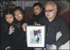  ?? ASSOCIATED PRESS ?? Cassandra Quinto-Collins (second from left) holds a photo of her son, Angelo Quinto, while sitting with daughter Bella Collins (left), son Andrei Quinto (center) and husband Robert Collins during an interview in Antioch, Calif. Angelo Quinto died Dec. 23, three days after being restrained in police custody while having a mental health crisis.