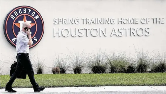  ?? Karen Warren / Staff photograph­er ?? Senior director of business operations Dan O'Neill enters the Astros’ facility, but members of the media weren’t allowed inside as was the case on the same day last year.