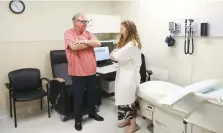  ?? Associated Press ?? ■ Dr. Jori Fleisher, neurologis­t, examines Thomas Doyle, 66, on July 9 at the Rush University Medical Center in Chicago. Doyle, 66, hopes blood tests may someday replace the invasive diagnostic testing he endured to be diagnosed 4.5 years ago with Lewy body dementia.