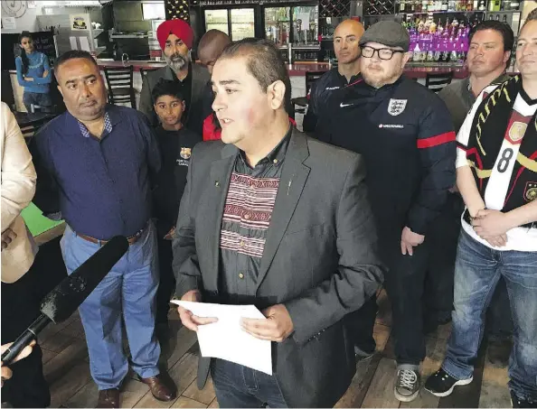  ??  ?? Edmonton-Ellerslie NDP MLA Rod Loyola announces Tuesday that Alberta will allow early alcohol sales for all liquor licensees during the FIFA World Cup. Loyola was joined at Jack’s Pizza Cafe in south Edmonton by soccer fans and cafe owner Deep Gill, left.