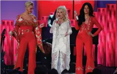  ??  ?? Katy Perry, Dolly Parton and Kacey Musgraves perform during the Grammy Awards tribute to the Queen of Nashville.