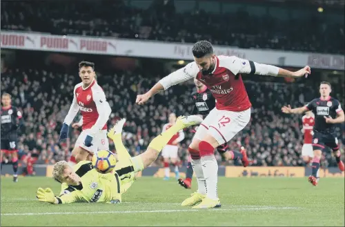  ?? PICTURE: PA ?? NOT THIS TIME: Huddersfie­ld Town goalkeeper Jonas Lossl thwarts Arsenal’s Olivier Giroud but could not prevent the Gunners cruising to victory at the Emirates Stadium.