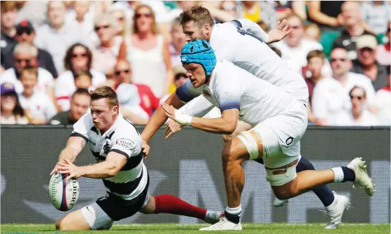  ?? PICTURE: Getty Images ?? Test pedigree: Chris Ashton scores one of his hat-trick of tries for the Barbarians against England