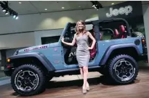  ?? Frederic J. Brown/afp-getty Images ?? Chrysler didn’t go all green in L.A., choosing as well to show off its new, off-road Jeep Wrangler 10th anniversar­y Rubicon edition.