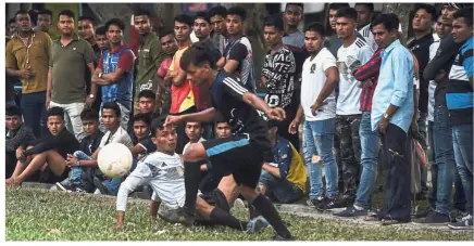  ?? — AFP ?? Brief respite: Rohingya refugees taking a break from their grinding existence to watch the football finals between Rohingya teams Selangor (in white) and Cheras Harimau (in black) during a recent three-day tournament for refugees.