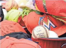  ?? STEVE MITCHELL, USA TODAY SPORTS ?? Fans have left caps, baseballs and other items with messages in a memorial for Jose Fernandez outside Marlins Park.