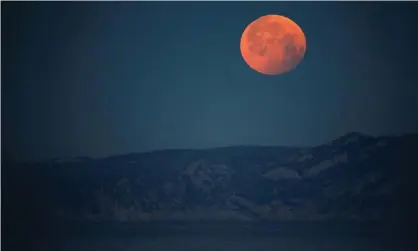  ?? Photograph: Jean-Paul Pélissier/Reuters ?? A super blood full moon in Marseille, France, 2019. You can look at this year’s May 2021 full supermoon and total lunar eclipse on Wednesday in Australia, over all of Oceania, most of south-east Asia and the Americas.