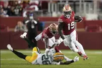  ?? TONY AVELAR — THE ASSOCIATED PRESS ?? San Francisco 49ers wide receiver Deebo Samuel (19) runs past Green Bay Packers free safety Darnell Savage (26) during the second half Sunday in Santa Clara.