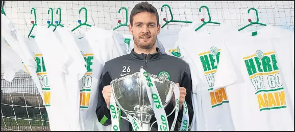  ??  ?? Craig Gordon shows off the QTS League Cup trophy as he helped to launch Celtic’s new range of merchandis­e ahead of this afternoon’s latest showdown with Dundee United