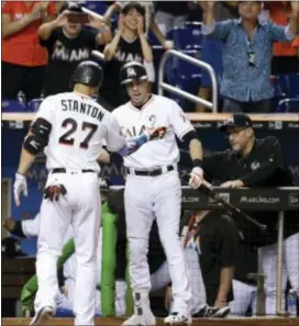  ?? LYNNE SLADKY — THE ASSOCIATED PRESS ?? Miami’s Giancarlo Stanton (27) is congratula­ted by Christian Yelich after hitting a solo home run during the third inning Tuesday in Miami.