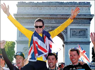  ??  ?? Record-breaker: Bradley Wiggins celebrates his 2012 Tour de France victory in Paris