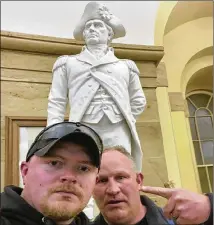  ?? UNITED STATES CAPITOL POLICE VIA AP ?? Rocky Mount (Va.) police Sgt. Thomas “T.J.” Robertson (right) and Officer Jacob Fracker pose in front of a Capitol statue of John Stark, who penned the “Live Free or Die” motto.