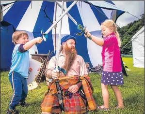  ??  ?? Jim Shankland keeps a close on the “battle” between Nairne Murray, 3, and sister Wyomia, 4.