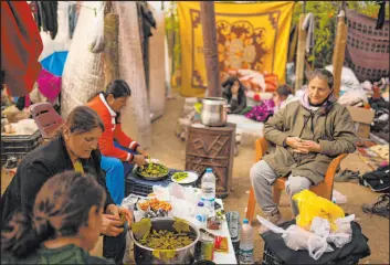  ?? Francisco Seco
The Associated Press ?? Women prepare a meal inside a greenhouse Thursday following the quake in Samandag, Turkey. The Feb. 6 earthquake destroyed tens of thousands of buildings.