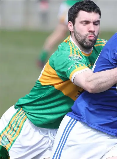  ??  ?? Ronan Byrne hangs onto JP Rooney during Sunday’s match between Sean O’Mahonys and Naomh Mairtin at Monasterbo­ice.