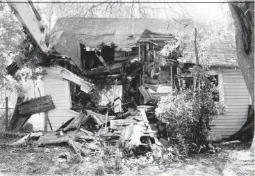  ?? J. Patric Schneider ?? An abandoned house off of Lavender Street is demolished during the fourth annual Demolition Day. The initiative on Saturday took down 31 homes in Houston.