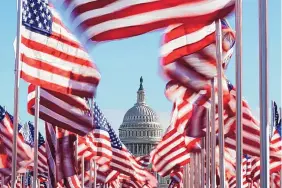  ?? ALEX BRANDON/ASSOCIATED PRESS ?? Flags on the National Mall frame the U.S. Capitol on Monday ahead of the inaugurati­on of President-elect Joe Biden and Vice President-elect Kamala Harris.