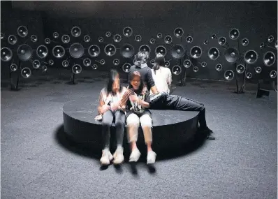  ?? LANCE MCMILLAN PHOTOS TORONTO STAR ?? Top, artist Jónsi sits within his installati­on Hrafntinna (Obsidian) at the Art Gallery of Ontario. The installati­on features a compositio­n played through numerous speakers that surround visitors, above, in a darkened room.