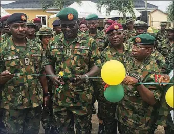  ??  ?? The Chief of Army Staff(COAS), Lieutenant General Tukur Buratai (second left); the Chief of Logistics, Nigerian Army headquarte­rs, Major General Enobong Udoh (fourth left); and the General Officer Commanding, 81 Division, Major General Musa Yusuf (fifth left) inaugurati­ng some projects in Lagos