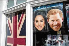  ?? CONTRIBUTE­D BY JACK TAYLOR/GETTY IMAGES ?? Masks of Prince Harry and Meghan Markle sit in the window of a gift shop May 10 in Windsor, England. St. George’s Chapel at Windsor Castle will host the wedding of Britain’s Prince Harry and U.S. actress Markle on May 19.