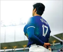  ?? ASHLEY LANDIS/THE ASSOCIATED PRESS ?? Los Angeles Dodgers designated hitter Shohei Ohtani stands Sunday as the national anthem plays before a spring training game against the Angels in Los Angeles.