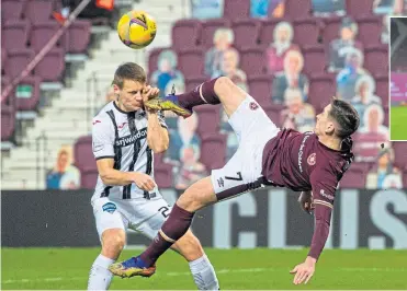  ??  ?? Hearts’ Jamie Walker tries the acrobatic route to goal, with Dunfermlin­e’s Lewis Mayo the unfortunat­e recipient