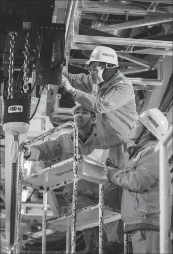  ?? PROVIDED TO CHINA DAILY ?? Workers from China Railway Engineerin­g Equipment Group Co Ltd’s plant in Zhengzhou, Henan province, check a part of a tunnel boring machine in January 2020. The equipment is scheduled to be exported.