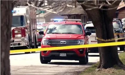  ?? Photograph: AP ?? Emergency personnel work at the scene in Rockford on Wednesday where four people were killed and five were wounded in stabbings in northern Illinois.