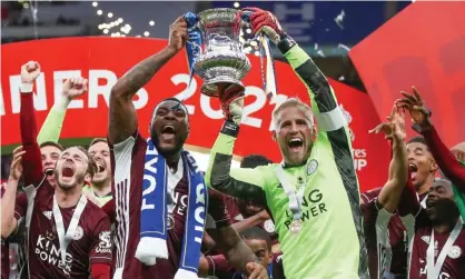  ??  ?? Kasper Schmeichel lifts the trophy with Wes Morgan, whose nine-minute cameo at the end of the game added to the sentiment of the occasion. Photograph: Nick Potts/EPA