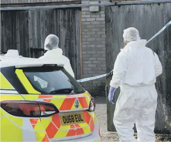  ??  ?? Police forensic teams searching a lock-up in Walton