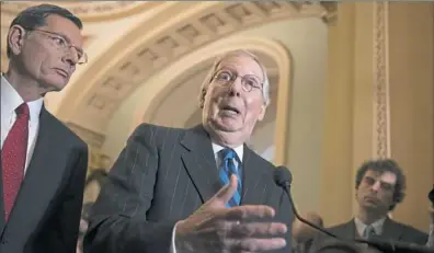  ?? J. Scott Applewhite/Associated Press ?? Senate Majority Leader Mitch McConnell, RKy., joined at left by Sen. John Barrasso, RWyo., meets with reporters as work continues on a plan to keep the government open as a funding deadline approaches, at the Capitol on Tuesday in Washington.