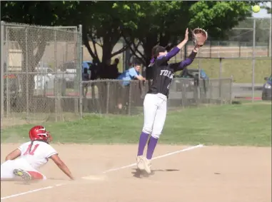  ?? PHOTOS BY MIKE BUSH/ NEWS-SENTINEL ?? Above: Tokay third baseman Sydney Giovannoni leaps for the ball while Lodi pinch-runner Dessa Zavala slides back toward third base in Wednesday's TCAL softball game at the Lodi Softball Complex. Left: Lodi third baseman Allisa Yabumoto tags out Tokay...