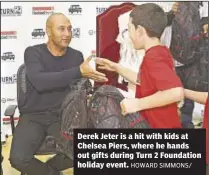 ?? HOWARD SIMMONS/ ?? Derek Jeter is a hit with kids at Chelsea Piers, where he hands out gifts during Turn 2 Foundation holiday event.