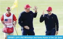  ?? — AFP ?? JERSEY CITY: Phil Mickelson and Kevin Kisner of the US Team react on the eighth green after winning the hole against Emiliano Grillo of Argentina.