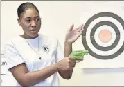  ??  ?? Marchelle Tigner goes over firearms safety tips during a class. She is among the nation’s black female gun owners who say they are picking up firearms for self-protection.