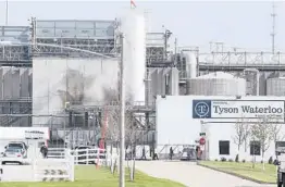  ?? BRANDON POLLOCK/THE COURIER ?? Tyson’s workers file in for a tour of safety measures put into place in May after the plant in Waterloo, Iowa, had to shut down due to a virus outbreak.