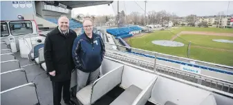  ??  ?? John Wilson, left, and ’Cats managing partner Jim Swanson in the new fan bus.