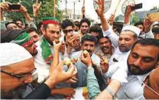  ?? AFP ?? Activists of the Pakistan Muslim League — Nawaz party protest against the Supreme Court decision against Pakistan’s Prime Minister Nawaz Sharif in Multan yesterday.