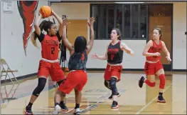  ??  ?? Russellvil­le freshman Taleigha Ealy tries to get the ball to her teammate, junior Jaidyn Koerdt, far right, while being guarded by sophomore Zariyah Willis, second from left, and junior Milah Wyborny.